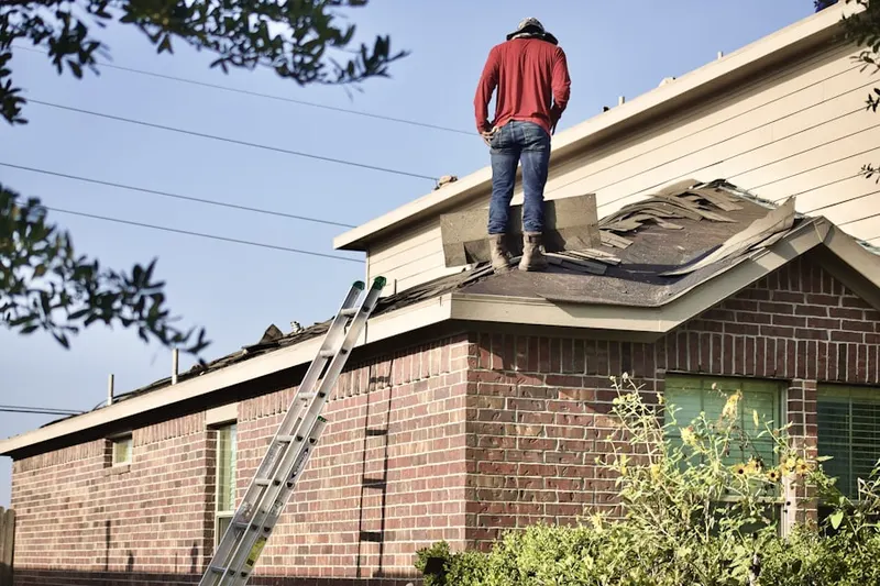 Professional roofer working on a residential roof in Broyhill Park